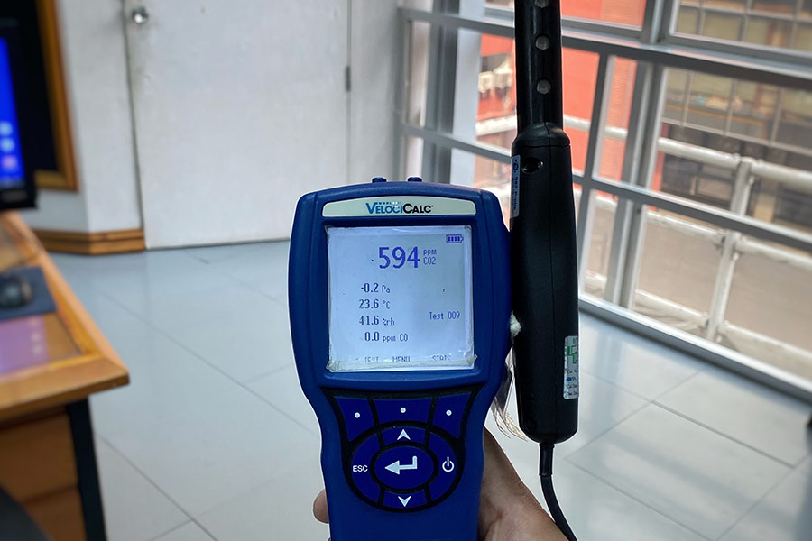 Air quality monitor showing CO2 levels and environmental data